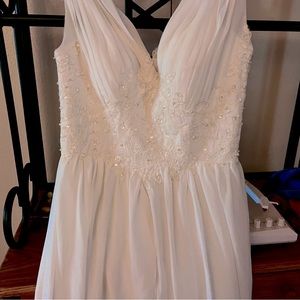 Beautiful wedding dress, never worn, intricate detail. Size 7.